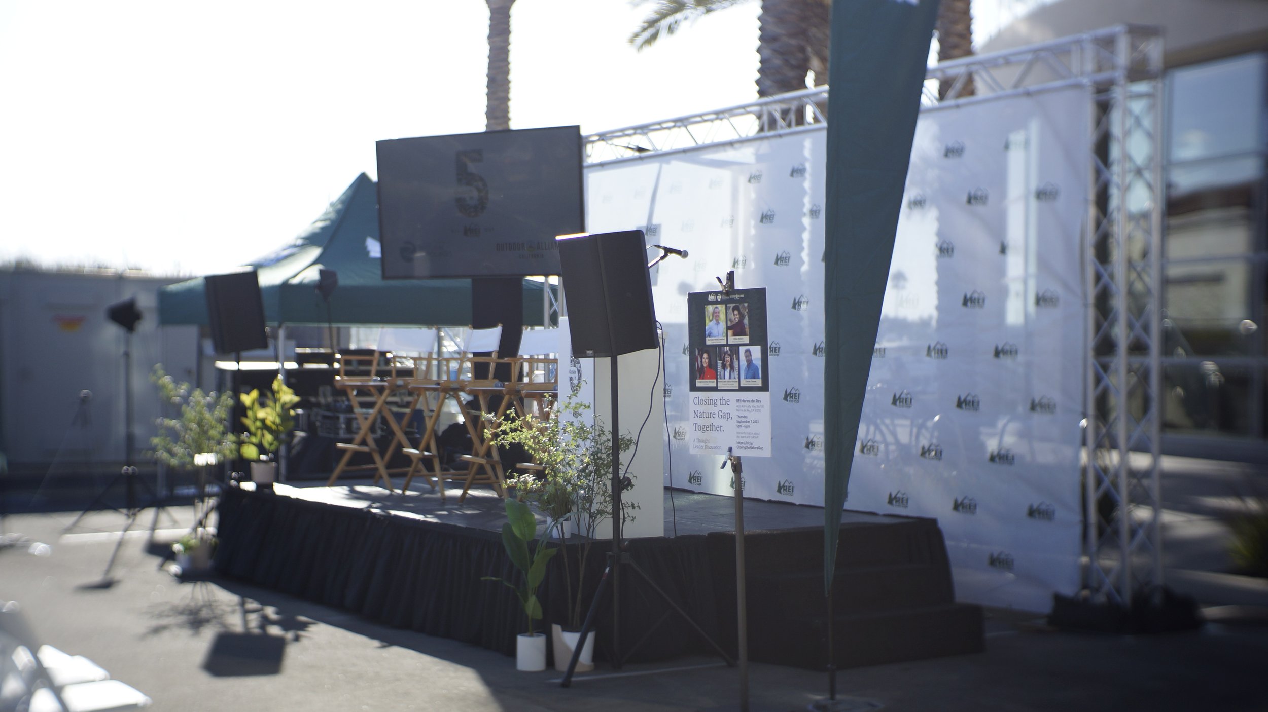 TV, speaker, step and repeat, and stage rental for an outdoor REI event in Los Angeles