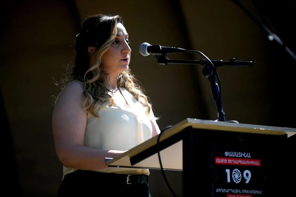 Keynote speaker speaking into a microphone rental for an outdoor event in Los Angeles